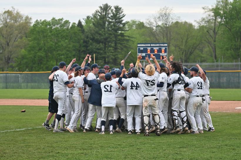 The Beloit baseball team gathered in a celebratory huddle.